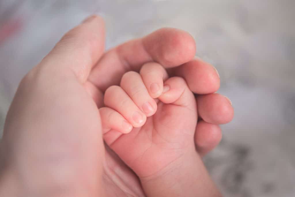 A newborn baby and parent